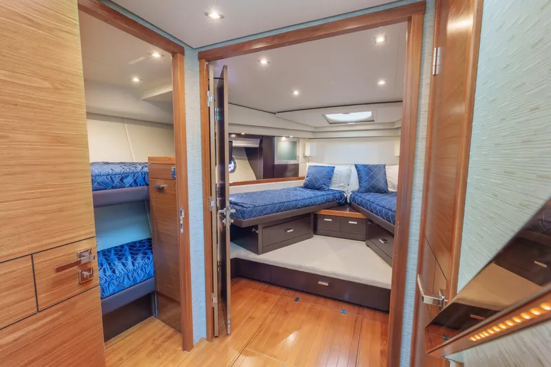 Happy Daze IV Yacht Photos Pics Luxurious 2017 Tiara Yachts C53 Coupe interior with elegant wood finishes and cozy bedding.