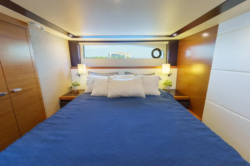 Happy Daze IV Yacht Photos Pics Luxurious 2017 Tiara Yachts C53 Coupe bedroom with elegant wood finishes and modern decor.