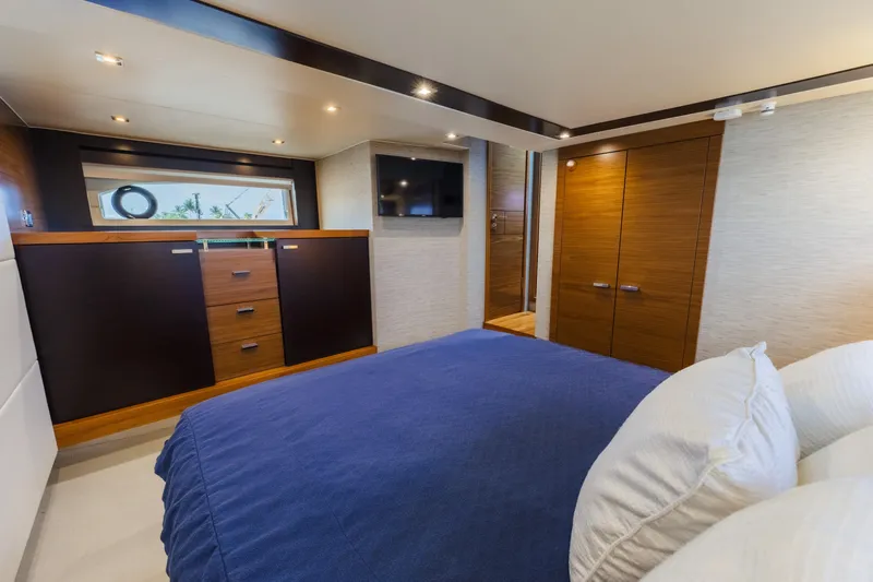 Happy Daze IV Yacht Photos Pics Luxurious bedroom interior of 2017 Tiara Yachts C53 Coupe with modern wood finishes.