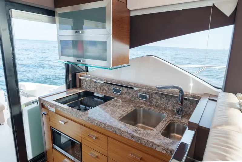Happy Daze IV Yacht Photos Pics Luxurious kitchen interior of 2017 Tiara Yachts C53 Coupe with ocean view.