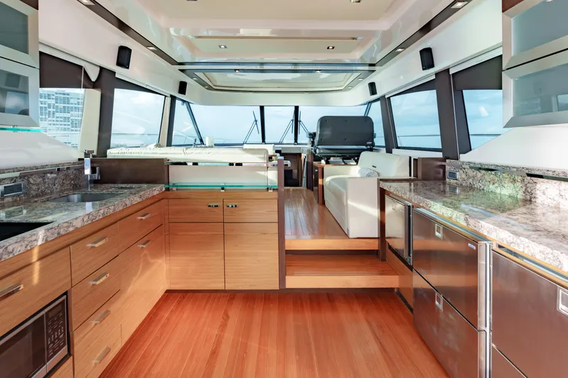 Happy Daze IV Yacht Photos Pics Luxurious interior of 2017 Tiara Yachts C53 Coupe with modern kitchen and panoramic windows.