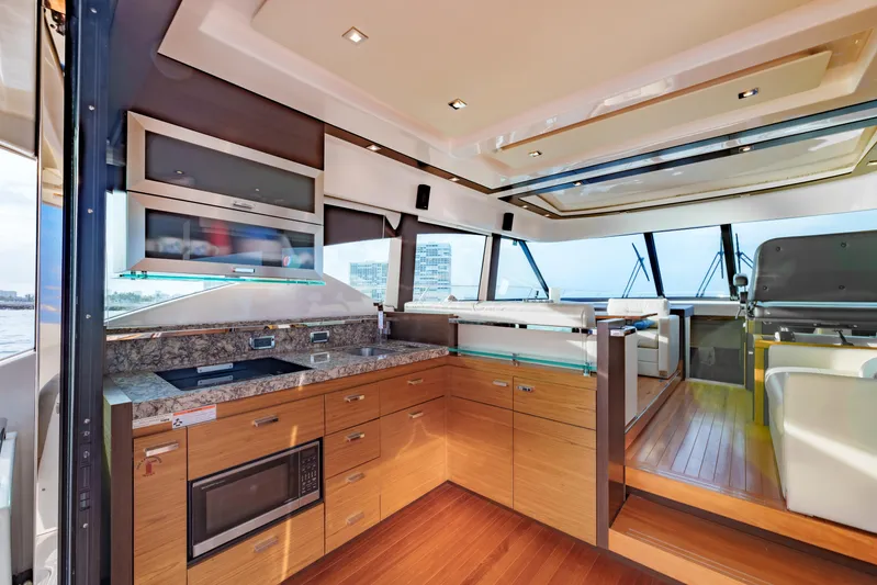 Happy Daze IV Yacht Photos Pics Luxurious interior of 2017 Tiara Yachts C53 Coupe with modern kitchen and panoramic windows.