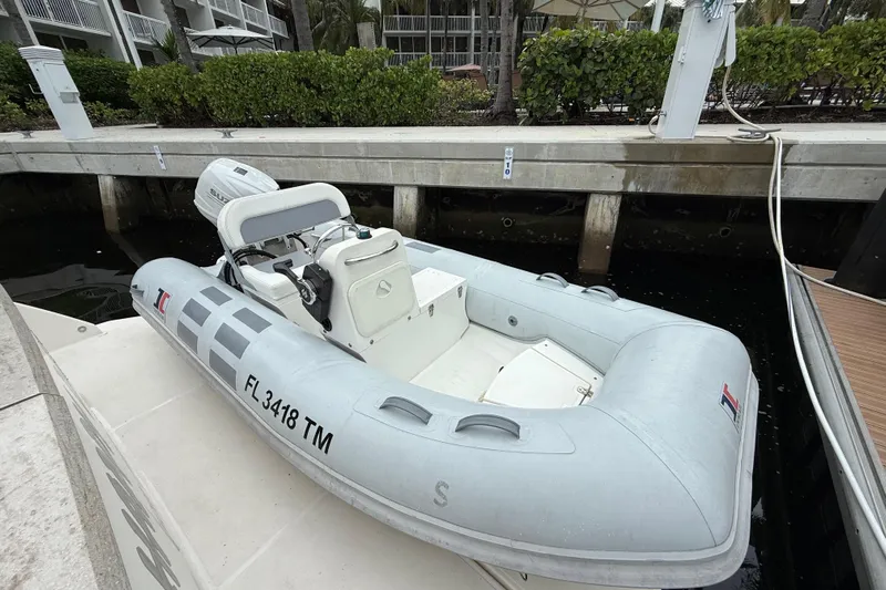 Happy Daze IV Yacht Photos Pics Inflatable boat docked beside a Tiara Yachts C53 Coupe, 2017 model.