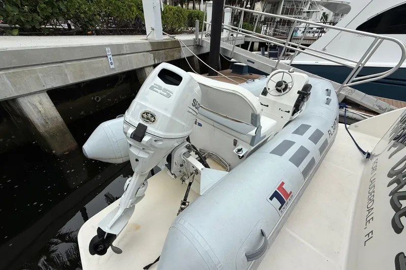 Happy Daze IV Yacht Photos Pics Inflatable boat with outboard motor docked beside a Tiara Yachts C53 Coupe, 2017 model.