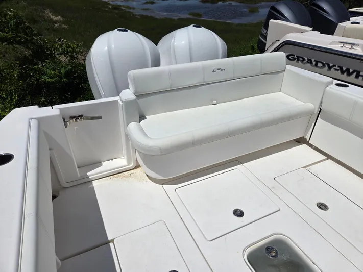White Cap Yacht Photos Pics 2016 Contender 32 ST boat interior with white seating and storage compartments.