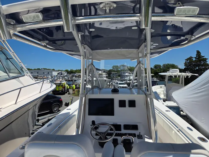 White Cap Yacht Photos Pics 2016 Contender 32 ST boat interior with steering console and canopy, docked at marina.