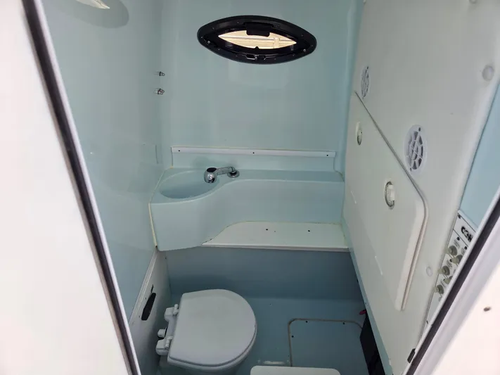 White Cap Yacht Photos Pics Interior of 2016 Contender 32 ST boat bathroom with sink and toilet.