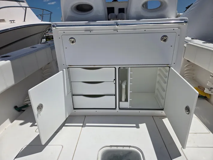 White Cap Yacht Photos Pics 2016 Contender 32 ST boat storage compartments with open doors and drawers.