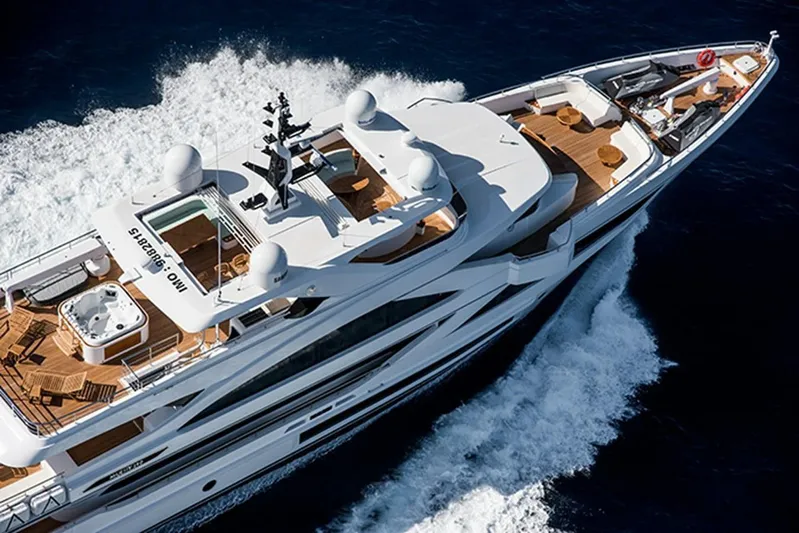 Checked Out Yacht Photos Pics Luxurious 2020 Majesty 140 yacht cruising on open water, aerial view.