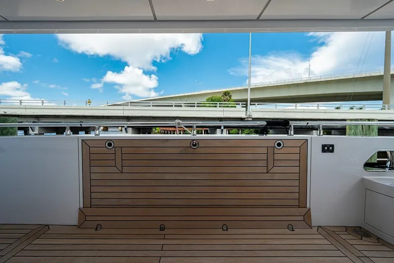 Checked Out Yacht Photos Pics Majesty 140 yacht deck, 2020 model, featuring sleek wood finish and modern design.