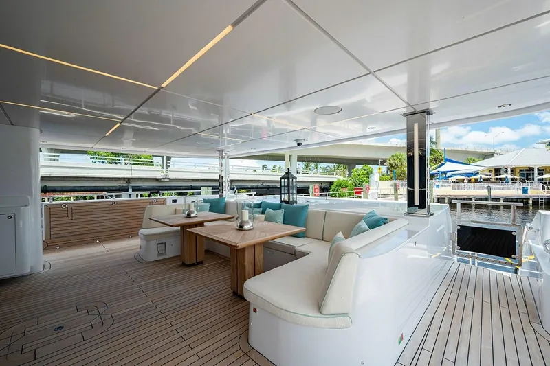 Checked Out Yacht Photos Pics Luxurious 2020 Majesty 140 yacht deck with elegant seating and wooden flooring.