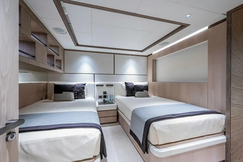Checked Out Yacht Photos Pics Luxurious twin bedroom in 2020 Majesty 140 yacht, featuring modern design and elegant decor.