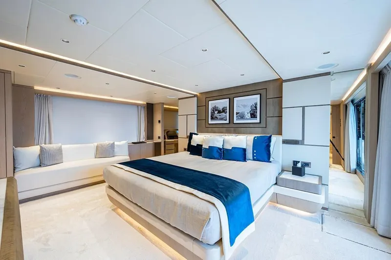 Checked Out Yacht Photos Pics Luxurious bedroom interior on 2020 Majesty 140 yacht, featuring elegant decor and modern amenities.