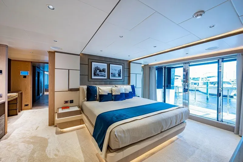 Checked Out Yacht Photos Pics Luxurious bedroom on 2020 Majesty 140 yacht with modern decor and marina view.