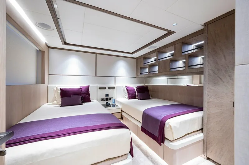Checked Out Yacht Photos Pics Luxurious twin bedroom on 2020 Majesty 140 yacht with modern decor and purple accents.