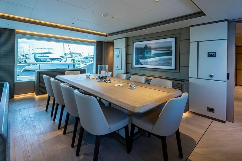 Checked Out Yacht Photos Pics Luxurious dining area on 2020 Majesty 140 yacht with elegant decor and marina view.