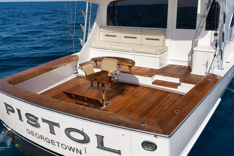 Pistol Yacht Photos Pics Luxury Weaver 60 Convertible yacht deck, 2002 model, with wooden flooring and seating.