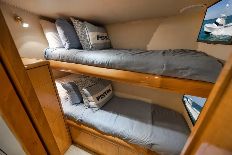 Pistol Yacht Photos Pics Bunk beds in 2002 Weaver 60 Convertible yacht cabin with blue bedding and wooden accents.