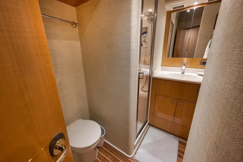 Pistol Yacht Photos Pics Bathroom interior of 2002 Weaver 60 Convertible yacht with shower and wooden cabinetry.