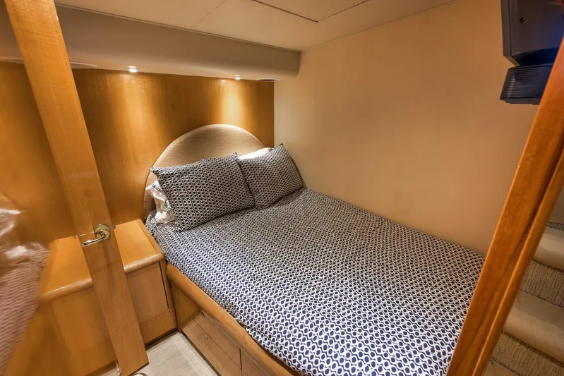 Pistol Yacht Photos Pics Cozy bedroom in 2002 Weaver 60 Convertible yacht with patterned bedding and wooden accents.