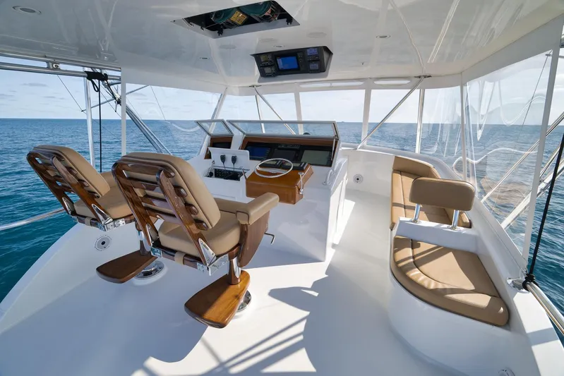 Pistol Yacht Photos Pics Luxurious Weaver 60 Convertible yacht helm with ocean view, featuring plush seating, 2002 model.