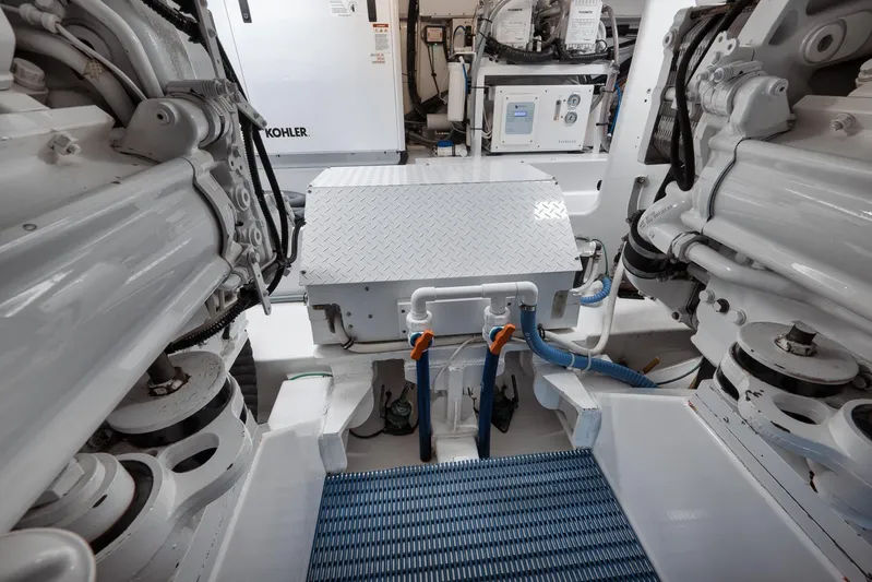 Pistol Yacht Photos Pics Engine room of a 2002 Weaver 60 Convertible yacht, featuring mechanical components and equipment.