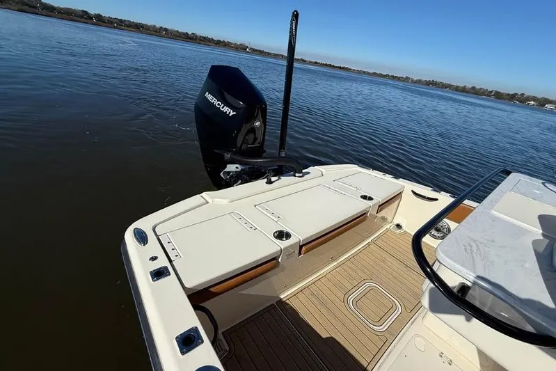  Yacht Photos Pics 2025 Scout 261 XSS boat with Mercury engine on calm water.