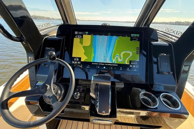  Yacht Photos Pics 2025 Scout 261 XSS boat dashboard with navigation display and steering wheel.