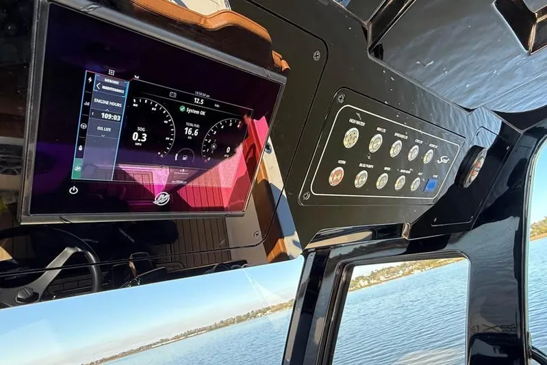  Yacht Photos Pics 2025 Scout 261 XSS boat dashboard with digital display and control panel.