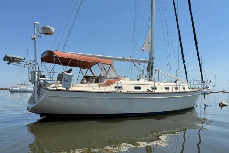 Juniper Yacht Photos Pics 2002 Island Packet 420 sailboat anchored in calm waters under a clear blue sky.