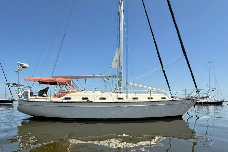 Juniper Yacht Photos Pics 2002 Island Packet 420 sailboat on calm water under clear blue sky.