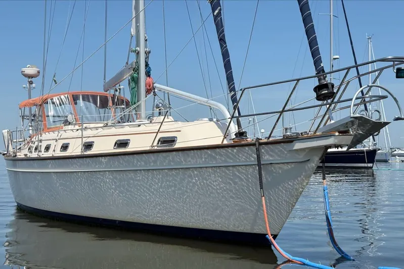 Juniper Yacht Photos Pics 2002 Island Packet 420 sailboat docked in calm marina waters.