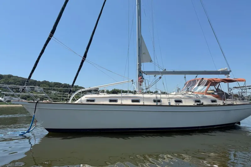 Juniper Yacht Photos Pics 2002 Island Packet 420 sailboat on calm water, clear sky background.