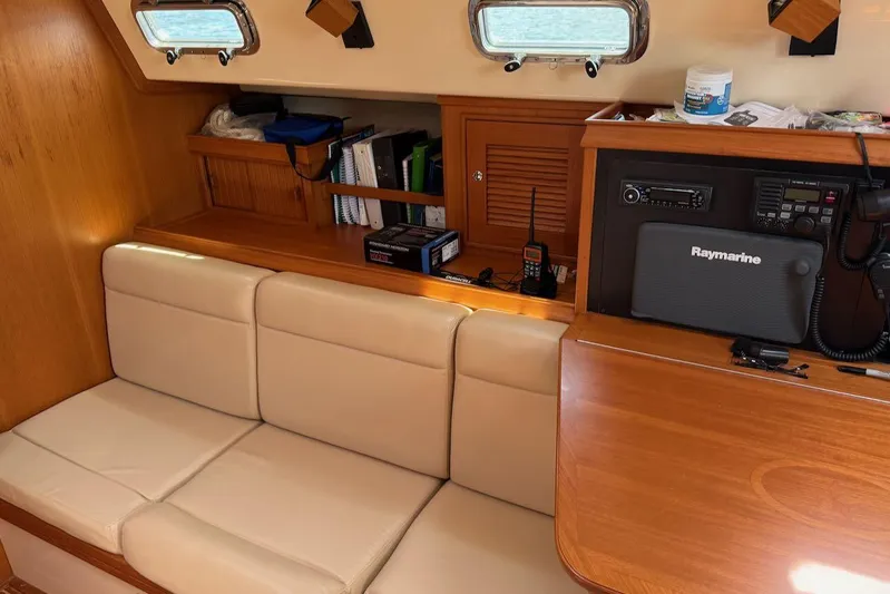 Juniper Yacht Photos Pics Interior of 2002 Island Packet 420 yacht with beige seating and navigation equipment.