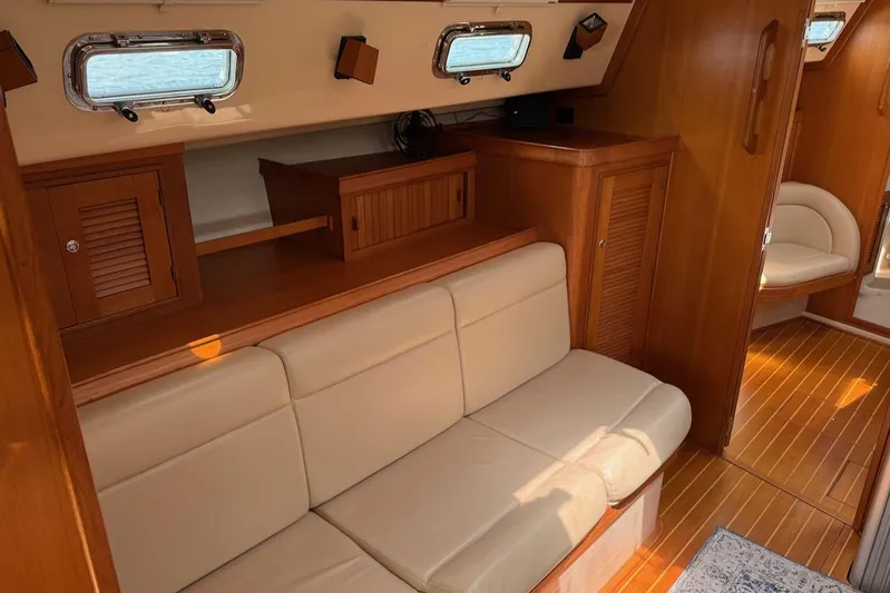 Juniper Yacht Photos Pics Interior of 2002 Island Packet 420 yacht with beige seating and wooden cabinetry.