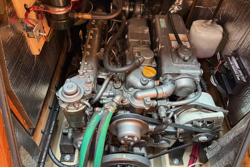 Juniper Yacht Photos Pics Engine compartment of a 2002 Island Packet 420 sailboat, showcasing mechanical components and wiring.