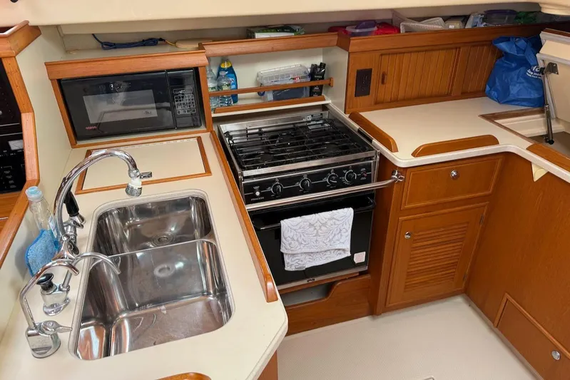 Juniper Yacht Photos Pics Island Packet 420 yacht kitchen with sink, stove, and microwave, 2002 model.
