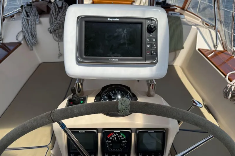 Juniper Yacht Photos Pics Cockpit of 2002 Island Packet 420 sailboat with navigation equipment and steering wheel.