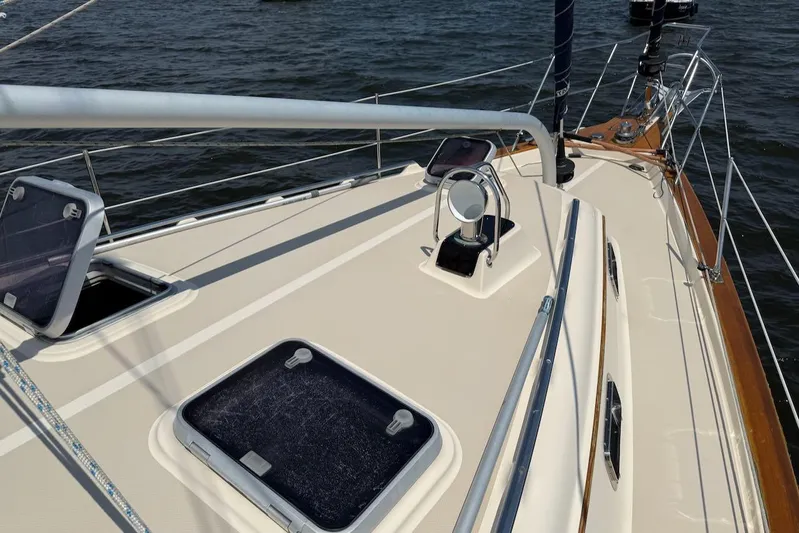 Juniper Yacht Photos Pics 2002 Island Packet 420 sailboat deck with open hatches on calm water.