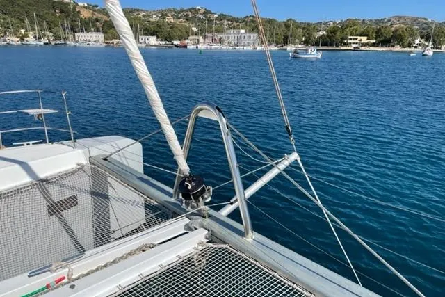 Mojito Yacht Photos Pics 2016 Lagoon 52 F catamaran on serene blue waters with coastal backdrop.