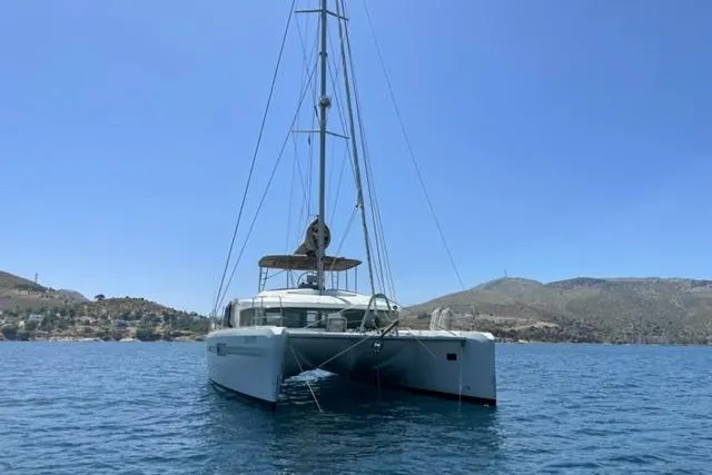 Mojito Yacht Photos Pics 2016 Lagoon 52 F catamaran sailing on calm blue waters under clear sky.