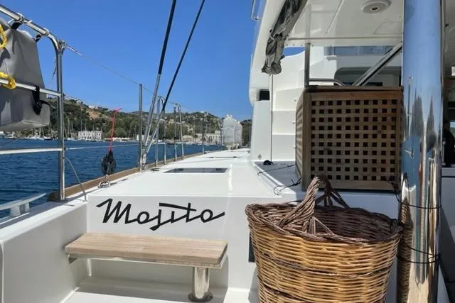 Mojito Yacht Photos Pics Lagoon 52 F 2016 yacht deck with wicker basket and scenic harbor view.