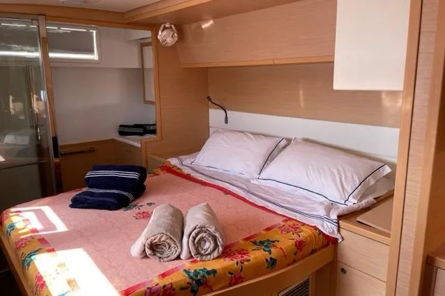 Mojito Yacht Photos Pics Luxurious cabin interior of 2016 Lagoon 52 F yacht with cozy bed and towels.