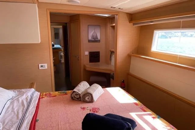 Mojito Yacht Photos Pics Luxurious cabin interior of 2016 Lagoon 52 F yacht with bed and window view.