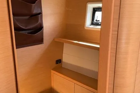 Mojito Yacht Photos Pics Interior of 2016 Lagoon 52 F yacht with wooden cabinetry and small window.