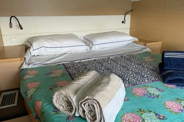 Mojito Yacht Photos Pics Luxurious cabin interior of 2016 Lagoon 52 F yacht with neatly arranged bed and towels.