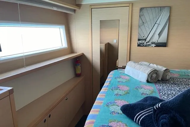 Mojito Yacht Photos Pics Luxurious cabin interior of 2016 Lagoon 52 F yacht with cozy bedding and nautical decor.