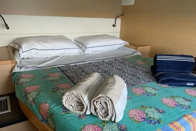 Mojito Yacht Photos Pics Cozy bedroom in 2016 Lagoon 52 F yacht with floral bedding and neatly folded towels.