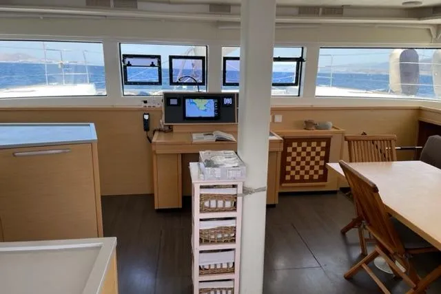 Mojito Yacht Photos Pics Interior of 2016 Lagoon 52 F yacht with navigation station and dining area.