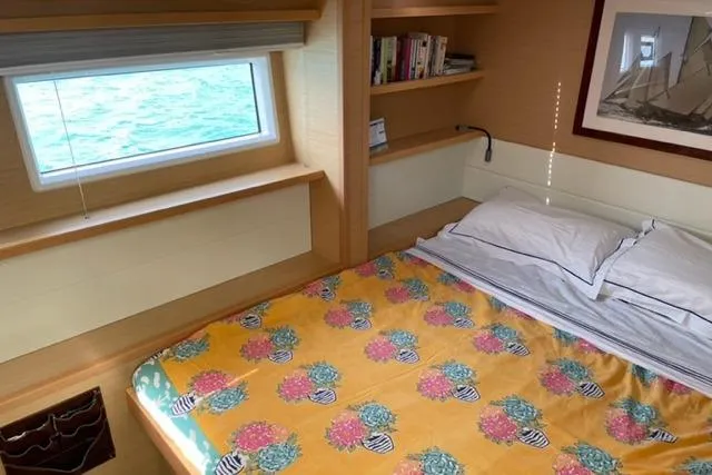 Mojito Yacht Photos Pics Cozy cabin interior of 2016 Lagoon 52 F yacht with colorful bedding and ocean view.